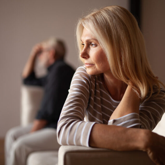 The older couple has a conflict. Upset mature woman, quarrel with her husband. Relationship crisis.